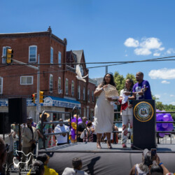 White dove release as part of the street renaming ceremony in Philadelphia, PA. Three people watching a white dove fly off at a street renaming ceremony.