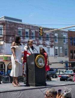 Family members of Lana Felton-Ghee giving speeches at the ceremony. Image of a lady giving a speech on  a stage on Philadelphia.
